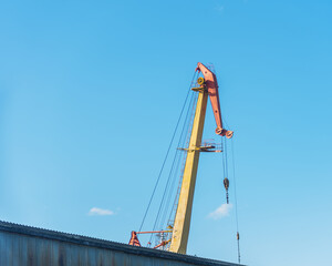 boom shipbuilding cranes on a background of blue sky, natural light.