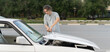 © Mihail - young driver has some car problems, open the car hood on a highway