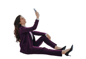 Successful businesswoman in violet suit sitting against transparent background holding phone, talking via video call. Gorgeous smiley lawyer happy to completed the case. Cheerful teacher at break