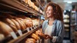 Happy woman choosing bread in a bakery