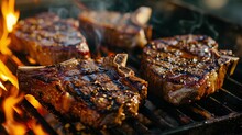 Juicy T-Bone Steaks With Grill Marks Cooking Over A Hot Charcoal Flame On A Barbecue Grill, Smoke Rising, Outdoor Summer BBQ Concept.
