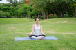 © Hip.hub - Young women have a beautiful bodies, Playing yoga in an elegant posture, in the green park, is a concept of people's recreation and health care concept. blurred background