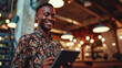 © Studio Nova - Man with a friendly smile, holding a tablet in a modern office environment