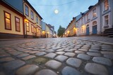 Fototapeta Uliczki - full moon casting light on an empty cobblestone street