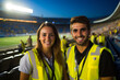 © AIproduction - Cheerful Young Stewards in Stadium