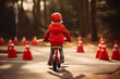 Youngster mastering bike riding near road cones