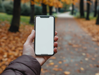Close up man hand showing and using smartphone with blank empty white sceen mock up in the park