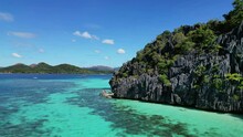 Aerial View Of Tropical Philippines Island. White Sand Beach, Rocks Cliffs Mountains With Blue Bay And Coral Reef, 4k