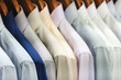 Men's shirts hang on hangers in the store, men's clothing for the office concept background