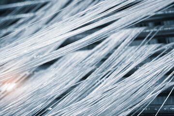 Aufkleber - synthetic textile thread,  thread at industrial weaving manufacturing machine,  textile fabric production industrial concept background