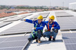 © FotoArtist - Specialist technician professional engineer checking top view of installing solar roof panel on the factory rooftop under sunlight. Engineers having service job of electrical renewable eco energy
