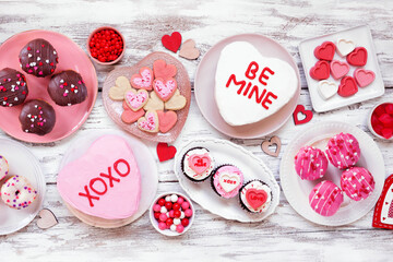 Aufkleber - Valentines Day table scene with a selection of fun desserts and sweets. Above view on a white wood background. Love and hearts theme.