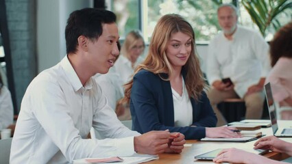 Wall Mural - Three confident multiethnic colleagues discuss project ideas together at office table meeting in busy office