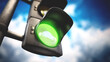 Traffic lamp with green light on against blue background. 3D illustration