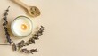 product image handmade candle from paraffin and soy wax in glass with wooden wick and dry herbal isolated on pastel beige background flat lay top view copy space
