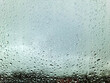 © Michael - Rain drops running down a window in a close up view.