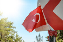 Waving Turkish Flag Tied To A Road Sign Post. Independence And Freedom