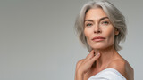 Fototapeta  - Anti-aging treatments and skincare concept. Beautiful mature woman with flawless skin and silver hairstyle