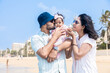 © GAJENDRRA BHATI  - Young indian father and mother embracing their cute little daughter and enjoying summer vacation on tropical beach. Happy family Concept.