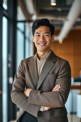 Wall Mural - Young happy Asian business man looking at camera standing in office. Smiling confident professional Japanese businessman executive, company employee or entrepreneur wearing suit, Generative AI 