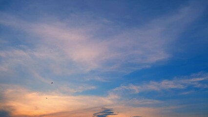 Wall Mural - In a rapid dance, day turns to night. Clouds streak across the canvas, sunset's beauty racing against time, a mesmerizing time-lapse spectacle. Cloud background. Timelapse.
