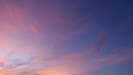 Wall Mural - Fast-motion photography captures a dynamic sunset, where the sky morphs through brilliant shades, while billowing clouds rush to embrace twilight. Sunset sky timelapse.
