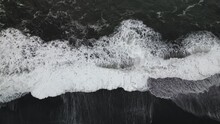 Cinematic Aerial Top View Over Ocean Waves Crashing On Iceland Solheimasandur Black Sand Beach