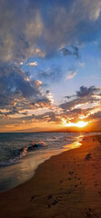 Wall Mural - Colorful sunset on the sea. Mountain lake in the rays of the orange sun. Kyrgyzstan, Lake Issyk-Kul. natural background