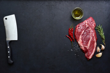 Wall Mural - Raw organic marbled beef steak with ingredients for cooking. Top view with copy space.