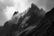 A monochromatic massif looms high above the fog-covered landscape, its summit hidden in the clouds, creating a serene and majestic outdoor scene