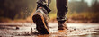 The soldier's feet walk through the mud. Selective focus.