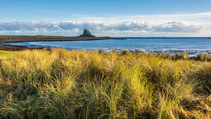 Wall Mural - Stunning dramatic landscape image of Lindisfarne, Holy Island in Northumberland England during Winter