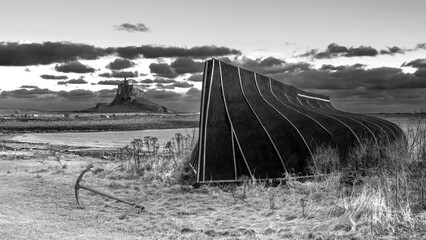 Wall Mural - Stunning  black and white dramatic landscape image of Lindisfarne, Holy Island in Northumberland England during Winter
