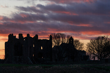 Wall Mural - Stunning dramatic landscape image of Lindisfarne, Holy Island in Northumberland England during Winter