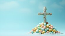 A Christian Cross And A Pile Of Easter Colored Eggs And Flowers. Easter Holiday.