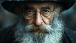 close up portrait of an old jewish man with long beard, hat and glasses, rabbi