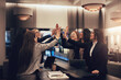 © Flamingo Images - Smiling businesswomen high-fiving during a meeting in a hotel lobby