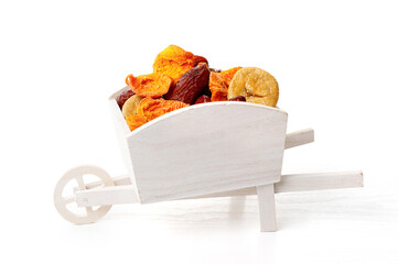 Wall Mural - Mix of dried fruits in a white wooden cart on a white background. Concept of the Jewish holiday Tu Bishvat (BeShvat)