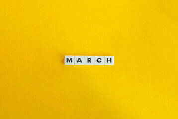 Wall Mural - March Word on Block Letter Tiles on Yellow Background. Minimalist Aesthetics.