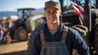 Young male farmer standing in front of tractors