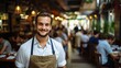 © duyina1990 - Confident waiter in apron standing in busy restaurant