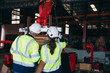 © NewSaetiew - Engineers inspecting and check up machine of the automated arms machine welding robots at factory. Technician controlling the automated arms machine welding robots..
