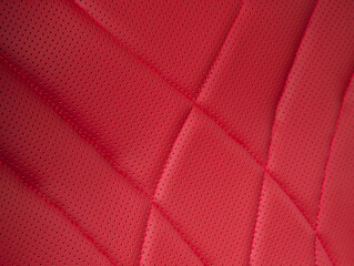 Wall Mural - Part of leather car headrest seat details. Сlose-up red   perforated leather car seat. Skin texture