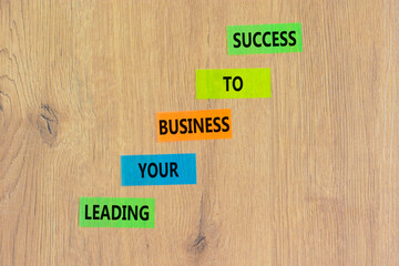 Wall Mural - Leading your business to success symbol. Concept words Leading your business to success on colored paper. Beautiful wooden background. Leading your business to success concept. Copy space.