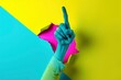 Hand pointing out of a hole in a pop art collage style in neon bold colors