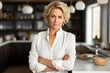 © Veronika - businesswoman standing in the kitchen