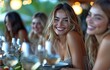 © tongpatong - Smiling female companions conversing while dining at a restaurant table.