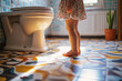 Little girl's legs in a bathroom. Training a toddler to use a toilet. Potty training, hygiene, childhood milestones.