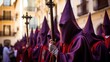 Holy Week , group of penitents holding a cross dresses  with vivid colors
