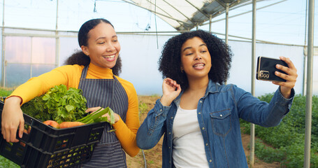 Two woman farmers filming selfie for social media, selling vegetables online